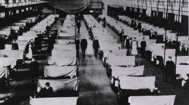 Spanish Flu Epidemic 1918-19. U.S. school gymnasium converted into an flu ward with patients' beds a